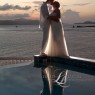 Bride and groom kiss with Caribbean Sea in background