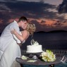 Bride and groom kiss after the cutting of the cake