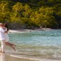 image of groom picking up his bride on Cimmamon Bay beach, St. John